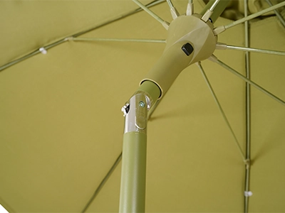 Blick unter das olivfarbene Schirmdach auf Mast, Knickgelenk und Streben.